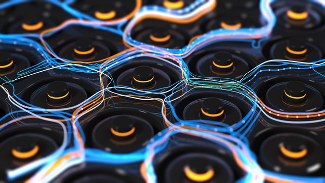 Many black batteries standing on their ends, with a hexagonal-like pattern of lights mimicking the flow of electrical current dancing between the tops of the batteries. 