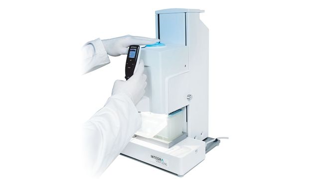 The Viaflo 96 on a white background with a Scientist using the machine 